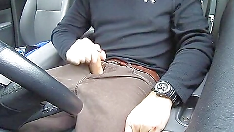 Girl in a tank top and red shorts drives in the car