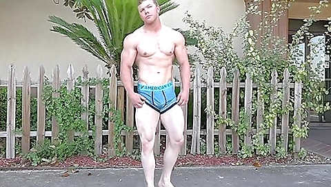 Mature bodybuilder poses in her underwear and shorts