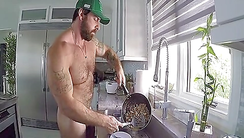 Tattooed chick with hot body shows off her curves while cooking