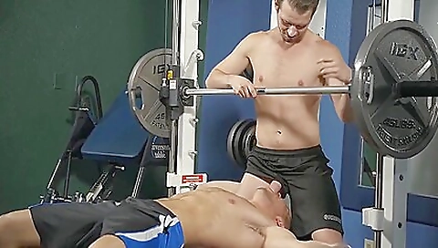Guy with massive thighs in black workout uniform in gym